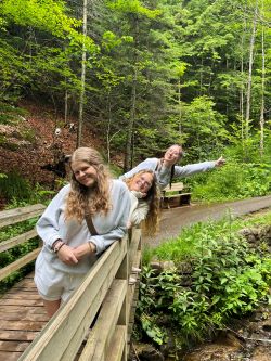 Ashley and friends on a bridge similing.